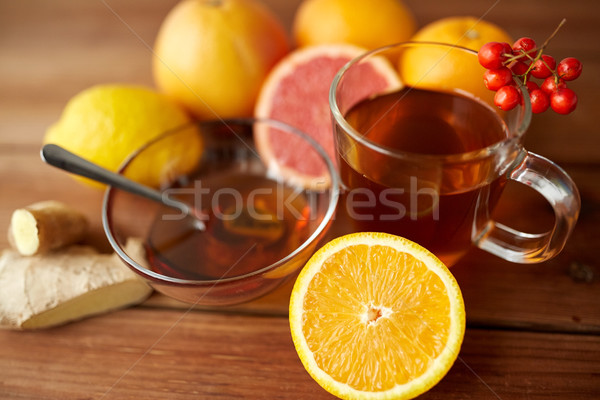 tea with honey, orange and rowanberry on wood Stock photo © dolgachov