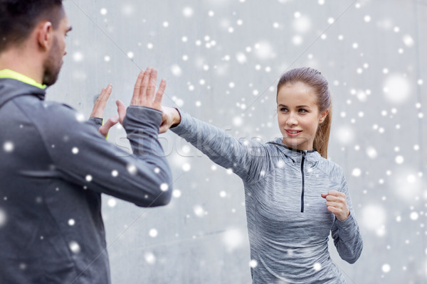 happy woman with coach working out strike outdoors Stock photo © dolgachov