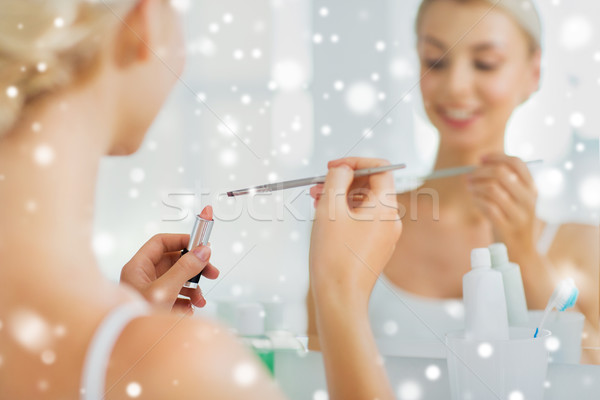 woman with lipstick and make up brush at bathroom Stock photo © dolgachov
