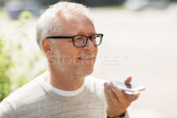 old man using voice command recorder on smartphone Stock photo © dolgachov