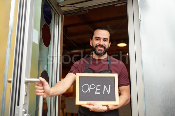 man or waiter with blackboard at bar entrance door Stock photo © dolgachov