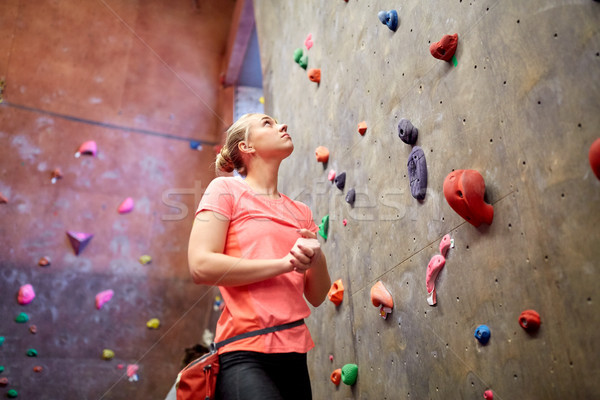 young woman exercising at indoor climbing gym wall Stock photo © dolgachov