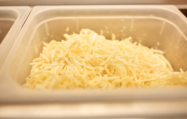 container with grated cheese at restaurant kitchen Stock photo © dolgachov