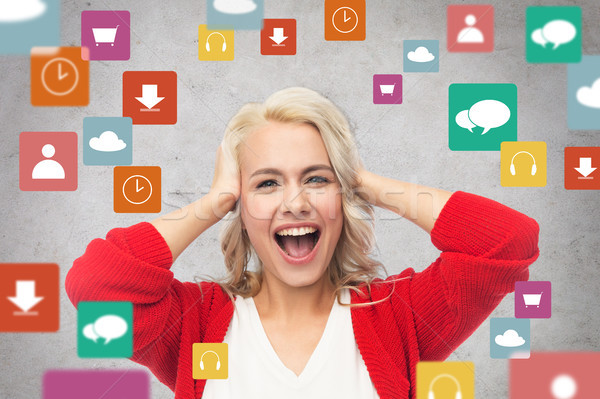 Stock photo: happy young woman holding her head and laughing