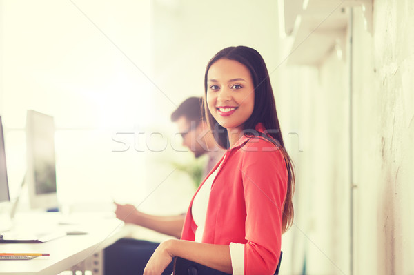 happy african woman with computer at office Stock photo © dolgachov