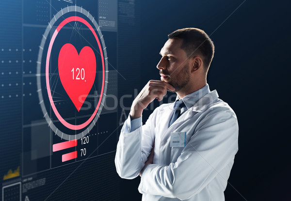 doctor or scientist in white coat with heart rate Stock photo © dolgachov