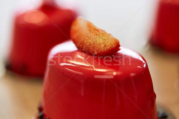 close up of mirror glaze cake at confectionery Stock photo © dolgachov