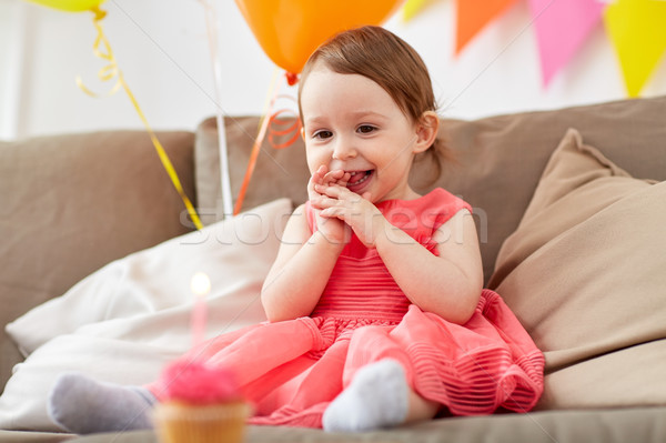 happy baby girl looking at birthday cupcake Stock photo © dolgachov