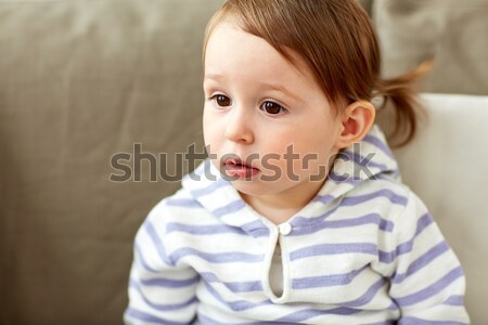 portrait of baby girl sitting on sofa at home Stock photo © dolgachov