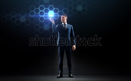 businessman with laser light over black Stock photo © dolgachov