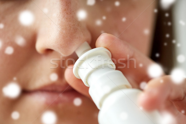 close up of sick woman using nasal spray Stock photo © dolgachov