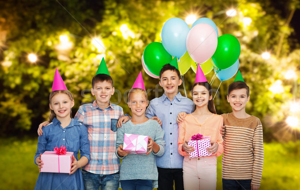 happy children with gifts at birthday party Stock photo © dolgachov