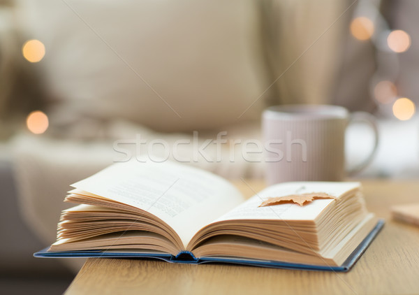 book with autumn leaf on wooden table at home Stock photo © dolgachov