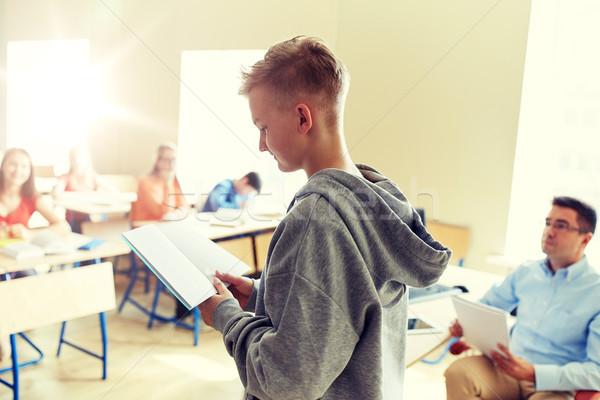 student boy with notebook and teacher at school Stock photo © dolgachov