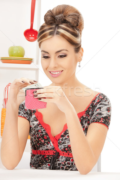 beautiful housewife with purse and money Stock photo © dolgachov