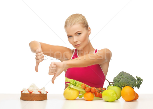 woman with fruits showing thumbs down to cake Stock photo © dolgachov
