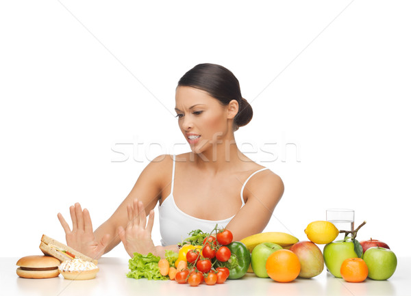 woman with fruits rejecting hamburger Stock photo © dolgachov