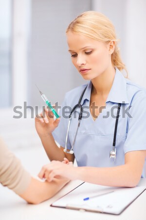 female doctor or nurse measuring blood pressure Stock photo © dolgachov