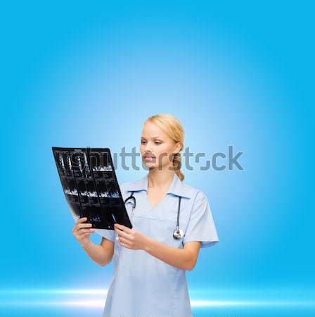 serious female doctor or nurse with stethoscope Stock photo © dolgachov