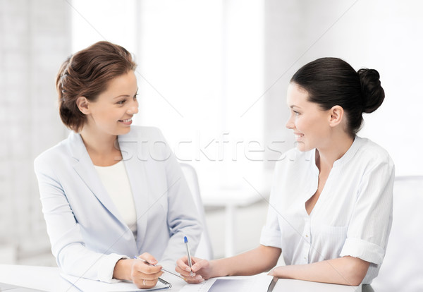 two businesswomen having discussion in office Stock photo © dolgachov