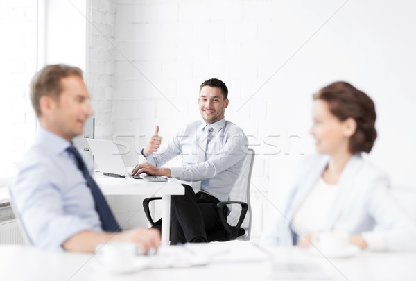 happy businessman showing thumbs up in office Stock photo © dolgachov