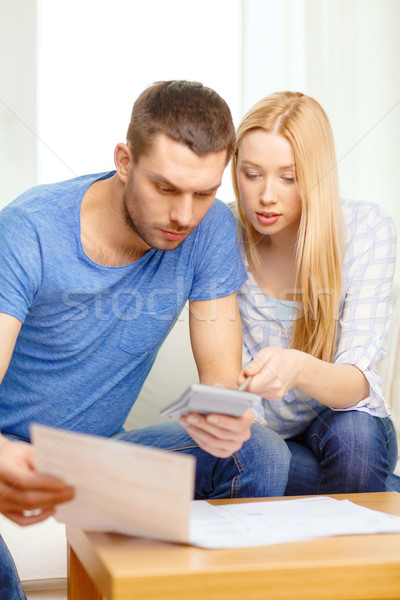 busy couple with papers and calculator at home Stock photo © dolgachov