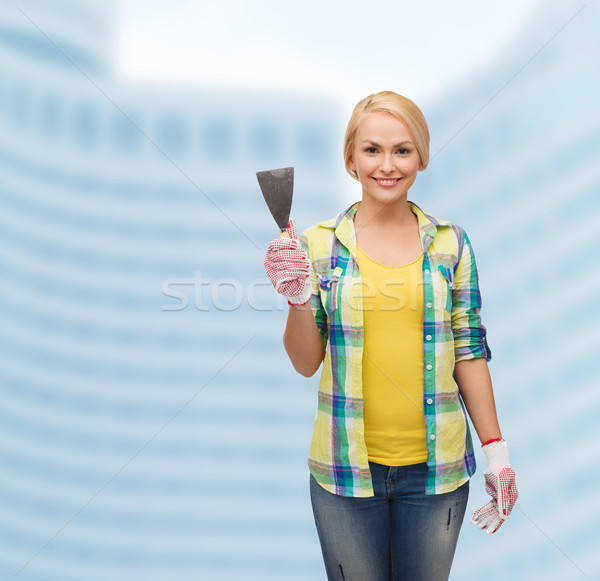 smiling female worker in gloves with spatula Stock photo © dolgachov