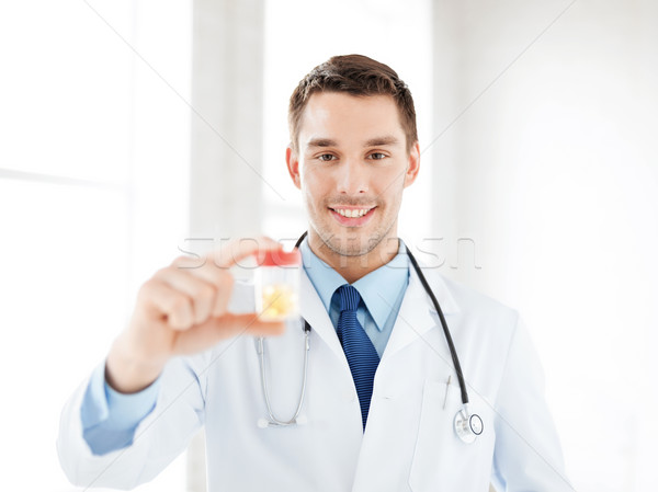 male doctor with jar of capsules Stock photo © dolgachov