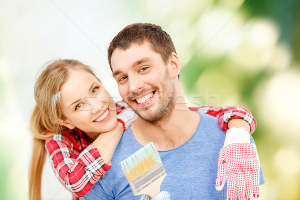Uśmiechnięty para pokryty farby pędzlem naprawy Zdjęcia stock © dolgachov