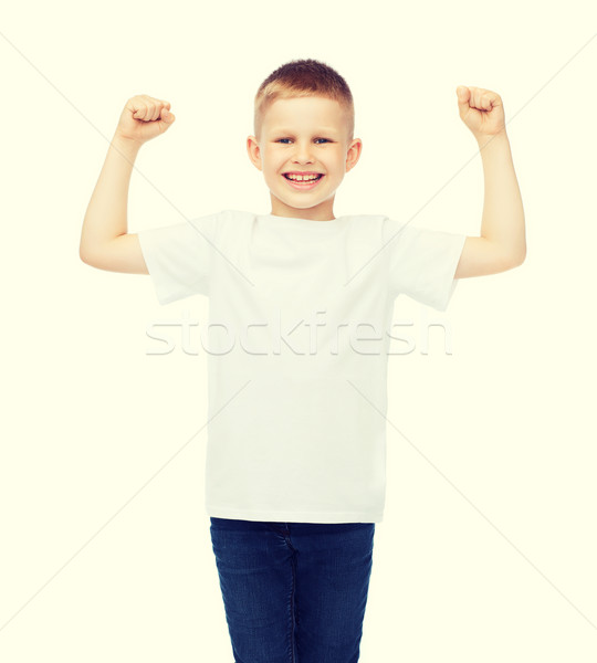 little boy in blank white t-shirt showing muscles Stock photo © dolgachov