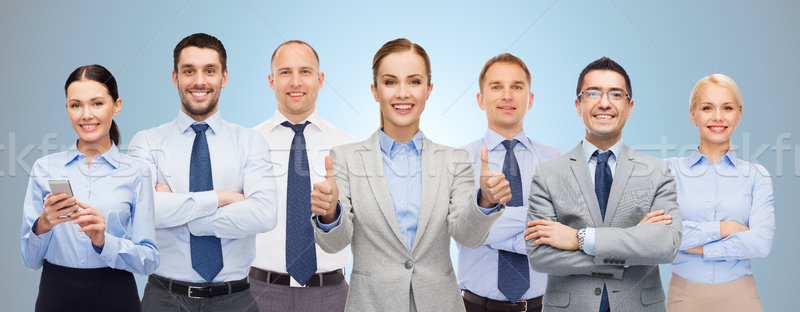 group of happy businesspeople showing thumbs up Stock photo © dolgachov