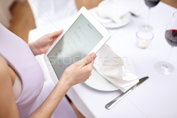 close up of woman with tablet pc at restaurant Stock photo © dolgachov