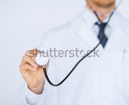 doctor hand with stethoscope listening something Stock photo © dolgachov