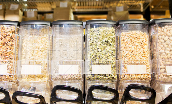 row of jars with nuts and seeds at grocery store Stock photo © dolgachov