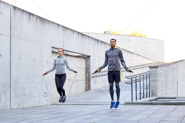 man and woman exercising with jump-rope outdoors Stock photo © dolgachov
