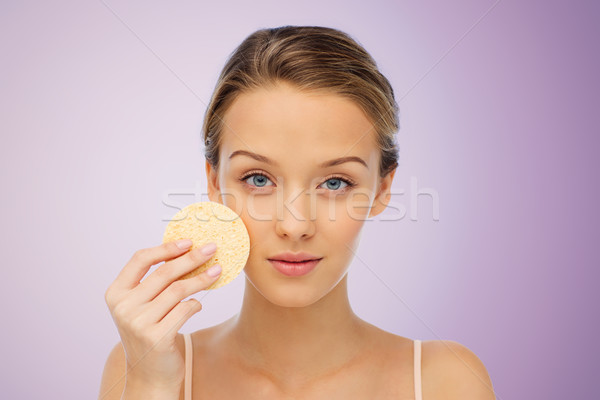 Młoda kobieta czyszczenia twarz gąbki piękna ludzi Zdjęcia stock © dolgachov