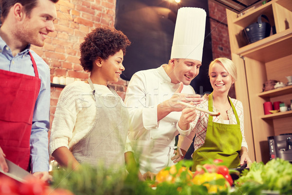 happy friends and chef cook cooking in kitchen Stock photo © dolgachov