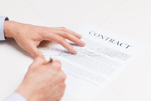 close up of male hands signing contract document Stock photo © dolgachov