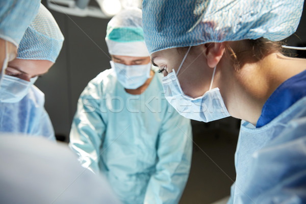 Stock photo: group of surgeons in operating room at hospital