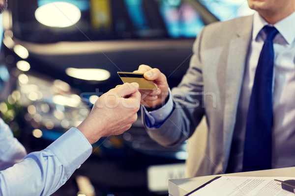 customer giving credit card to car dealer in salon Stock photo © dolgachov