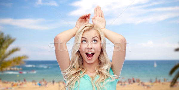 Heureux souriant jeune femme lapin oreilles [[stock_photo]] © dolgachov