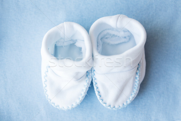 close up of baby bootees for newborn boy on blue Stock photo © dolgachov