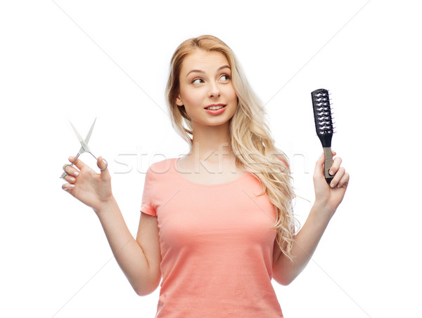 Stock photo: young woman with scissors and hairbrush