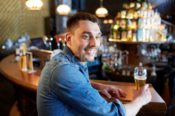 happy man drinking draft beer at bar or pub Stock photo © dolgachov