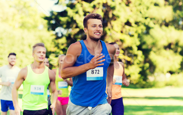 happy young sportsmen racing wit badge numbers Stock photo © dolgachov