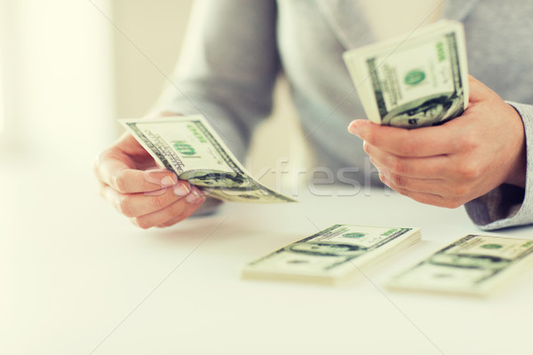 Stock photo: close up of woman hands counting us dollar money
