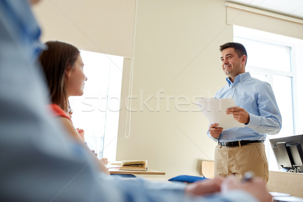 group of students and teacher with papers or tests Stock photo © dolgachov