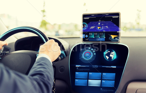 Stock photo: close up of man driving car with navigation system