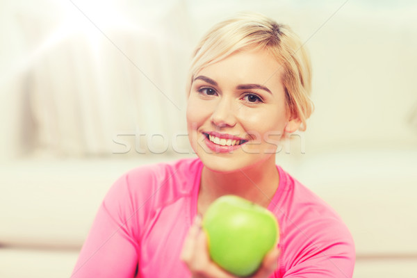 happy woman eating green apple at home Stock photo © dolgachov