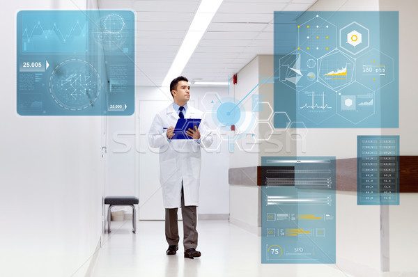 doctor with clipboard walking along hospital Stock photo © dolgachov